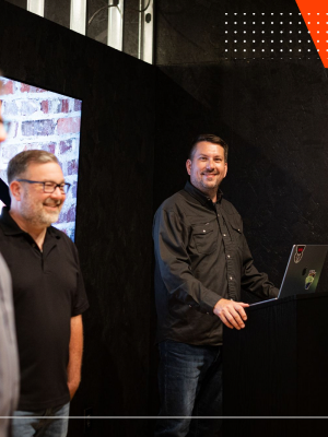 Two WWC team members presenting work on a laptop