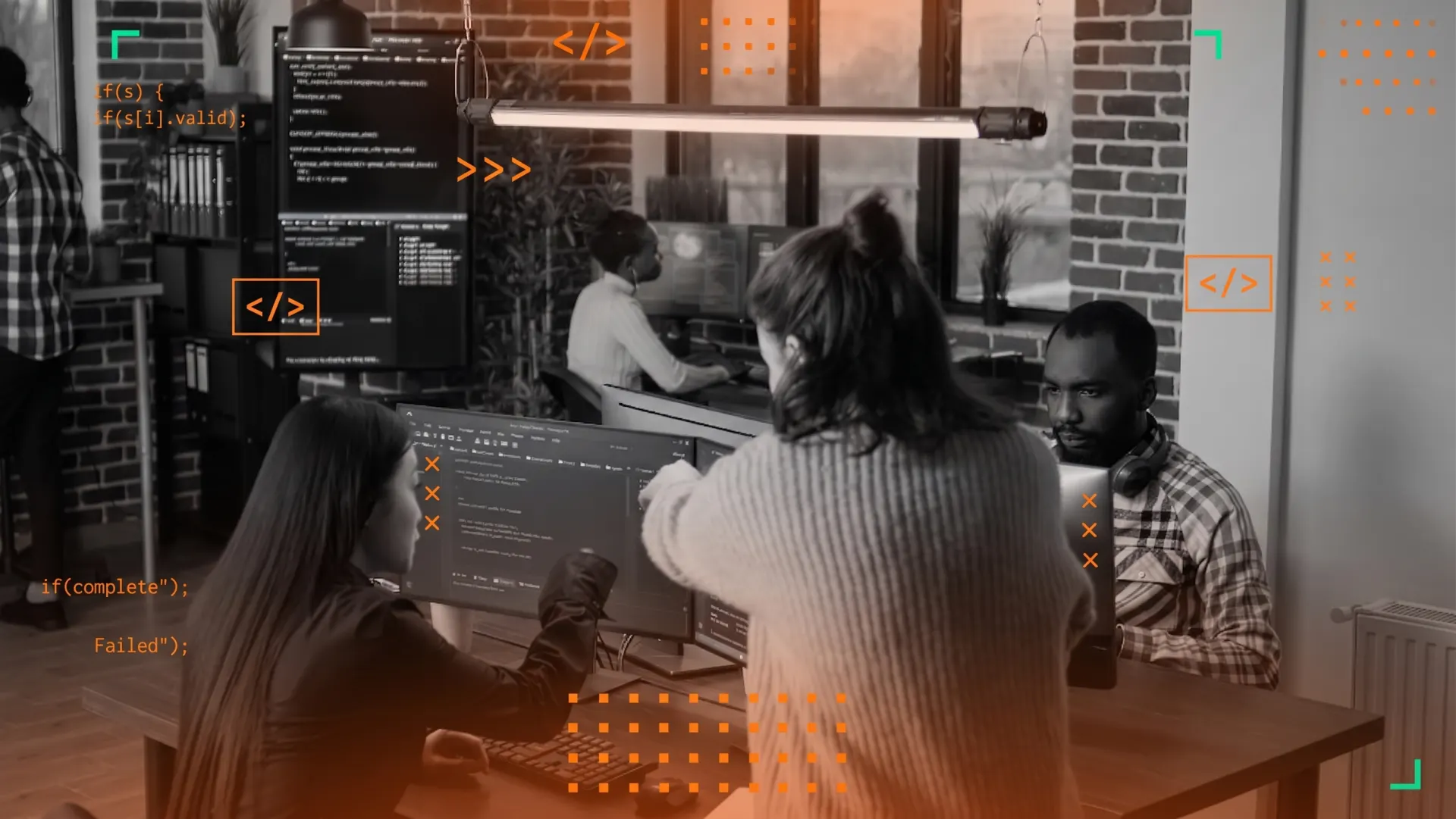 Team collaborating around monitors with code