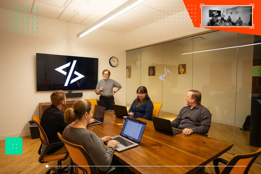 Team meeting around a conference table discussing strategy