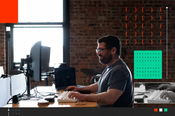 Developer working at a desk with multiple monitors