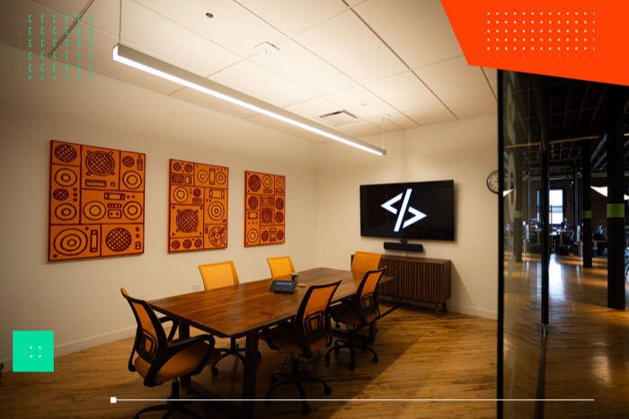 WWC conference room with the team's code logo on screen