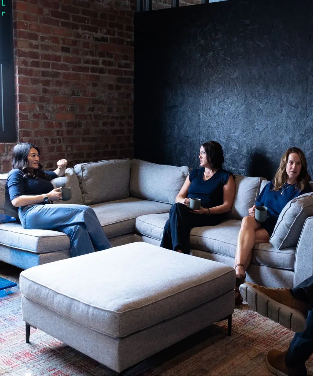 WWC team members having a conversation in a lounge area