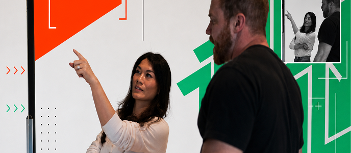 Woman presenting at a whiteboard during team meeting