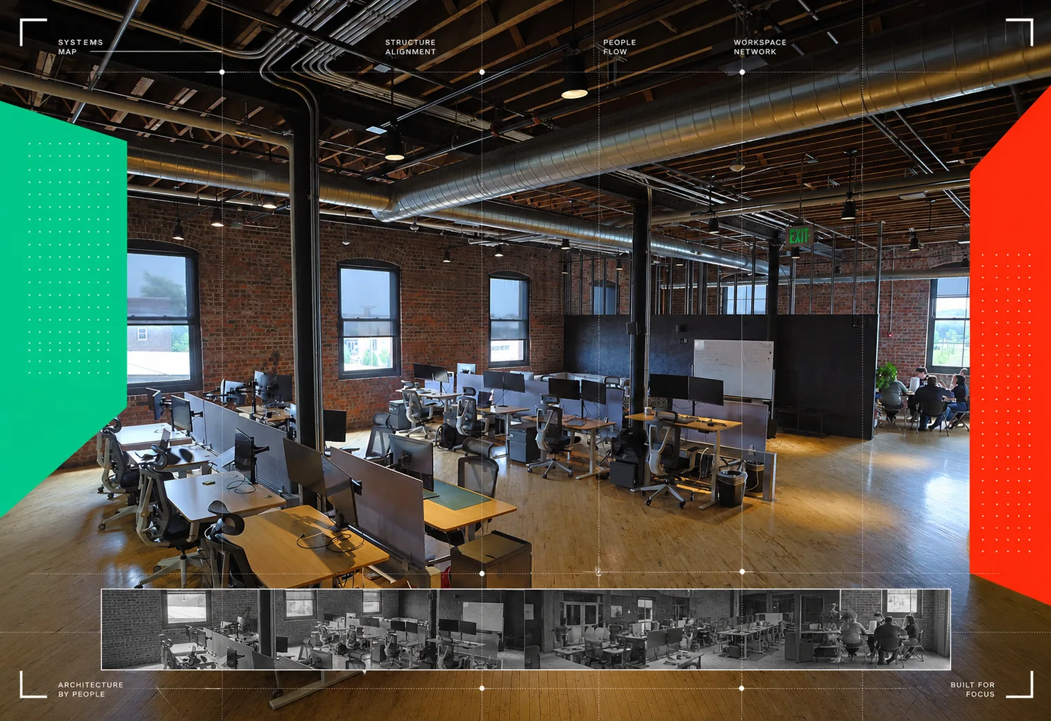 Open office floor with desks, monitors and exposed brick