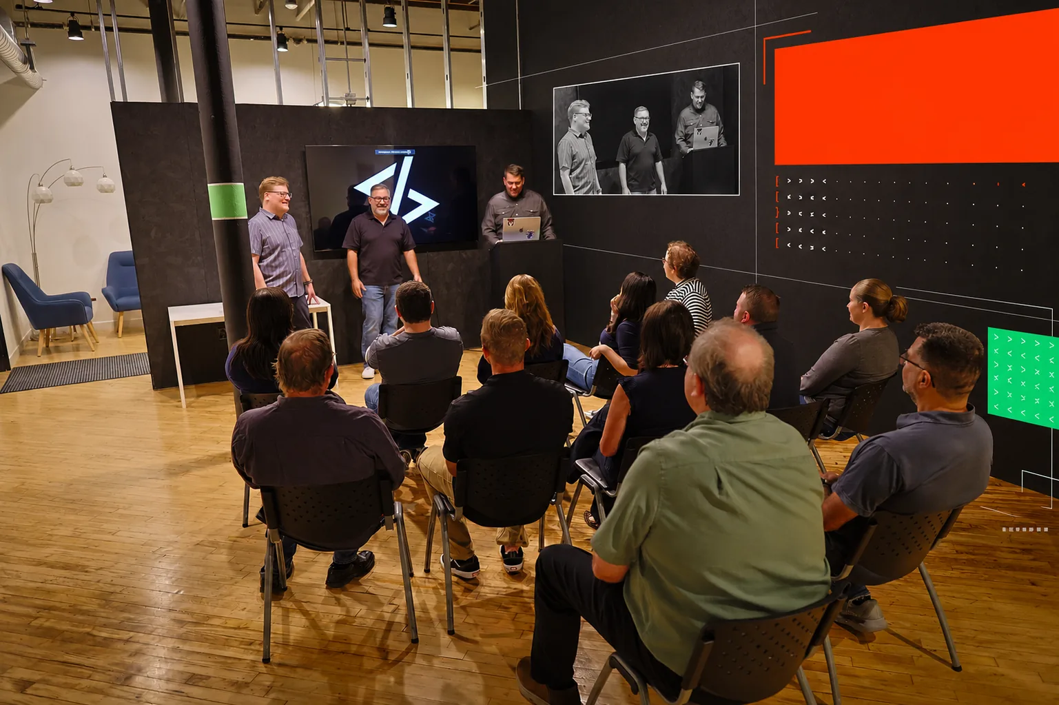 WWC team presenting to a seated audience in the office